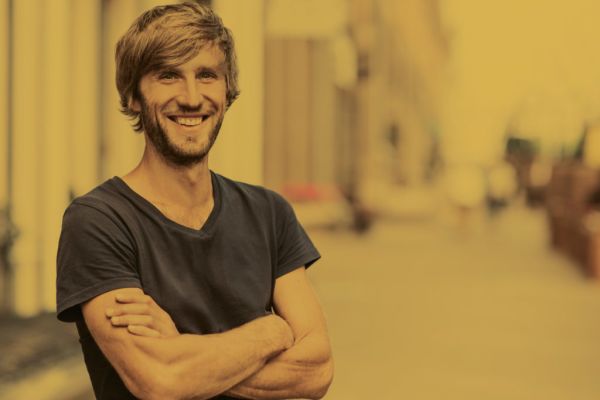 smiling man with his arms folded