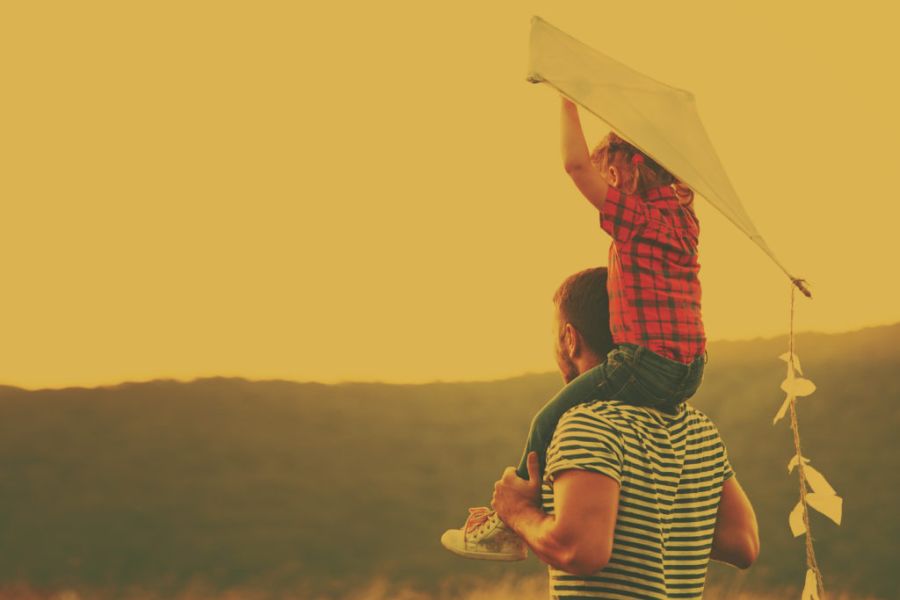 boy on shoulders with a kite